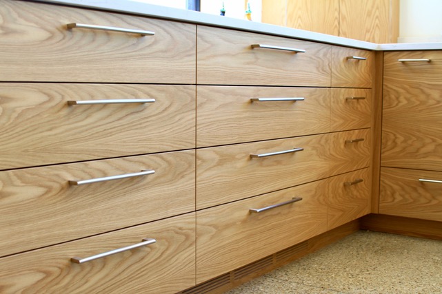 A set of brown kitchen cabinets.